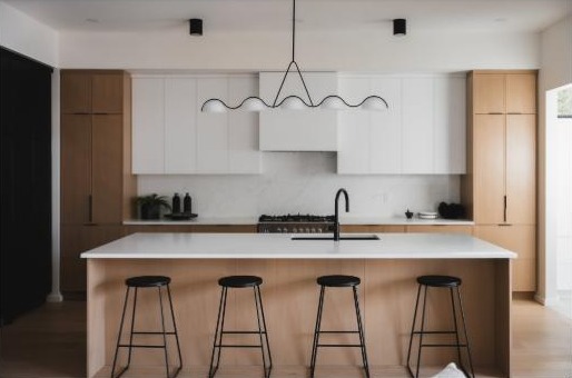 Kitchen island with seating overhang and black stools by Finesse Countertops, Edmonton