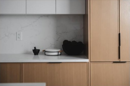 Kitchen countertop with patterned backsplash by Finesse Countertops, Edmonton