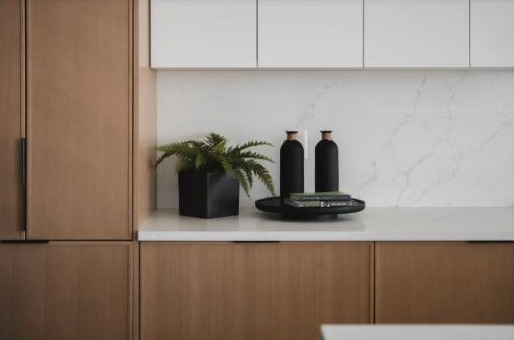 Warm wood cabinets with stone countertop by Finesse Countertops, Edmonton